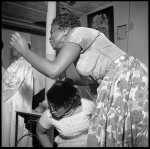 [Store Front Churches. A woman helps another woman to her seat who has become deeply moved during a church service at Pastor Bishop H. Abdullah's church in Buffalo, New York]