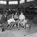 Freedom Riders Charles Butler, Catherine Burks Brooks, Lucretia Collins, and Salynn McCollum seated on a bench at the Greyhound station in Birmingham, Alabama.