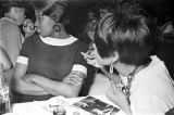 Barbara Howard Flowers and her sister, Princilla Howard, seated at a table at the Laicos Club in Montgomery, Alabama.