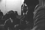 Martin Luther King, Jr., seated and speaking to a young man during a meeting at Maggie Street Baptist Church in Montgomery, Alabama.