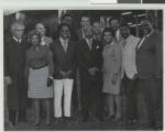 Black and white group photograph of (L-R) Judge Robert Reid, Mabel Hoggard, Aaron Williams, Bill Evans (Education), Herschel L. Williams (2nd row), Claude Perkins (2nd row), Theron Goynes, Claude Parson, Helen Anderson Toland, James Pughsley, John Shippe, and Judge Robert "Moon" Mullen