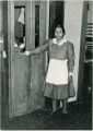 Two maids at telephone booth