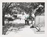 Mississippi State Sovereignty Commission photograph of Garland Lyle [sic], Robert Burton and Jack Anderson standing near a Confederate monument on the grounds of the Mississippi State Capitol while Richard Barrett walks along sidewalk, Jackson, Mississippi, 1967 July 30