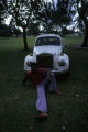 Man sitting in front of vintage car