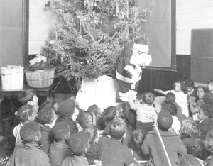 Santa passing out Christmas presents to children at Phyllis Wheatley House, Minneapolis.