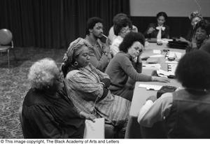 Photograph of individuals attending a conference meeting