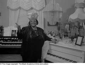 Photograph of gospel singer Francine Morrison posing with her awards #3