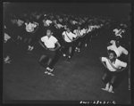 [Untitled photo, possibly related to: Washington, D.C. With "Victory through good health" as a slogan, Negro schools held a show at the Uline arena stressing the importance of physical fitness in wartime and demonstrating their physical education programs. Fourth and fifth grade children take part in the physical education show]