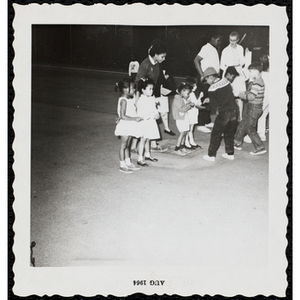 Contestants and their brothers running an egg-and-spoon race during a Boys' Club Little Sister Contest