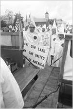 Klansmen standing behind two pickup trucks during a Ku Klux Klan rally in Montgomery, Alabama.