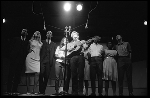 Bob Dylan leading performers on stage, Newport Folk Festival Left to right: Peter Yarrow, Mary Travers, Paul Stookey, Joan Baez, Bob Dylan, Bernice Reagon, Cordell Reagon, Charles Neblett, Rutha Harris, Pete Seeger