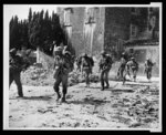 [African American soldiers on patrol near bombed buildings, somewhere in Europe]