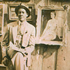 Joseph Delaney seated in front of sidewalk art exhibit