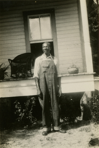 Gullah man in front of his house