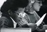 A Marquette Law School student reads a paper in a classroom, 1988