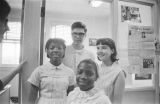 Jim Peppler with Rubye Howard, Wilhelmina Howard, and Beth Falk at the Southern Courier office in the Frank Leu Building in Montgomery, Alabama.