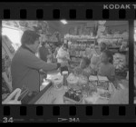 Kyu Chang Lee, waiting on young customers in his Central Avenue grocery in Los Angeles, Calif., 1986