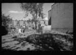 Thumbnail for White girls playing in slum section near Capitol inhabited mostly by Negroes. Note Capitol dome in right background. Washington, D.C.