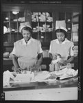 Answering call for volunteer nurses aides. The call for 100,000 volunteer nurses aides to relieve the acute shortage of graduate nurses is answered by Negro housewives and mothers throughout the country. At Freedmen's Hospital in Washington, D.C. where an eighty-hour training courses has been in progress since last October. Volunteers begin practical training in the central dressing room. Photo shows Mrs. Louis Lucas (left) and Miss Susie Freeman (right) wrapping bandages