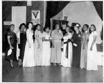 Group photograph of women standing next to stage