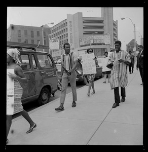 Members of a maverick Philadelphia brand of the NAACP, one gripping a garrison belt, paraded the group's 58th annual convention at the Sheraton-Boston Hotel Thursday carrying placards and chanting phrases