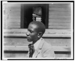 [African American boy, head-and-shoulders portrait, left profile]