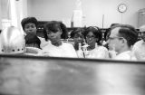 Man explaining scientific equipment to a group of students from Lee County, Alabama, during a field trip to Auburn University.