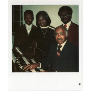 The Hunter family poses in front of a Hammond organ