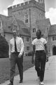 Two men walking on sidewalk at Duke University.