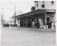 Mississippi State Sovereignty Commission photograph of the rear entrance to Stanley's Cafe and the Trailways bus depot with three African American males standing outside, Winona, Mississippi, 1961 November 1