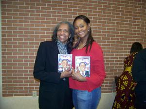 Two women holding Barack Obama DVD