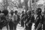 Police officers standing between protestors and marchers at a United Klans of America march in Mobile, Alabama.