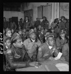 [Photograph of several Tuskegee airmen attending a briefing in Ramitelli, Italy, March 1945]