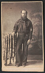 [Petty Officer Jacob Lunger of U.S. Navy in uniform in front of painted backdrop showing landscape]