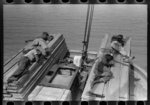 Negro stevedores sleeping on pile of lumber on bow of packet boat on Mississippi River below New Orleans, "El Rito"