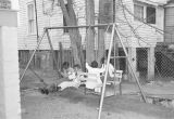 Children seated on a swing set at the Children's Hope Center at 487 South Jackson Street in Montgomery, Alabama.