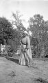 Lethe, an African American woman, sweeping in a dirt yard, probably in Furman, Alabama.