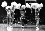 Marquette cheerleaders perform a routine on the basketball court, 1976-1977