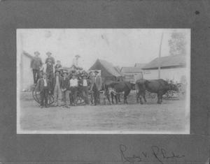 Twelve Men Standing in Front of and on Top of a Wagon