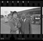 Jin Lee with Reverend Huey Rachal outside Lee's dairy store in Los Angeles, Calif., 1986