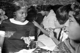 Barbara Howard Flowers with her sister, Princilla Howard, and another women, seated at a table at the Laicos Club in Montgomery, Alabama.