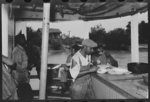 Negro stevedores eating on stern of boat. Food supplied to crew consists almost entirely of carbohydrates with some of the cheaper cuts of meat. Sleeping quarters are not provided for stevedores, who sleep in any available space. Aboard El Rito, Pilottown, Louisiana