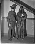 Police officer stands with R.F. McGarry, member of the Black Legion secret society, Los Angeles, 1936