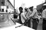 Police officers arresting Mattie Howard during the Children's Crusade in Birmingham, Alabama.