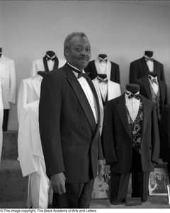 Photograph of John Dudley Ingram posing with tuxedos