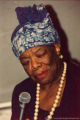 Maya Angelou holding a microphone