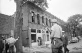 Thumbnail for Police officer standing guard in the street across from the Silver Sands Restaurant and the Liberty Contracting Company, which were damaged during the 16th Street Baptist Church bombing.