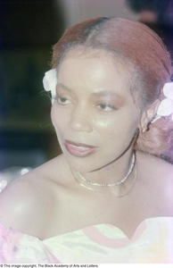 Photograph of Mollie Williams adorned in jewelry and hair accessories