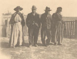 Four African Americans standing in front of a picket fence in Crawford, Alabama.