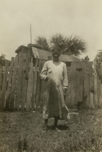 Gullah woman in front of fence